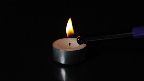 Lighter-lighting-a-tealight-candle