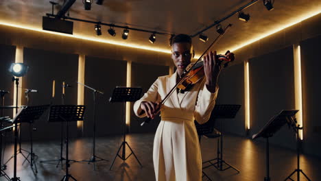 woman playing violin on stage