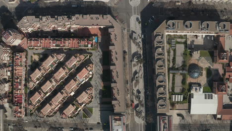 Modern-residential-complex-in-urban-borough.-Top-down-footage-of-group-of-buildings-in-square-blocks.-Barcelona,-Spain