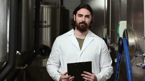 man with clipboard at brewery