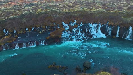 aerial drone footage of the underground rivers that flow and turn into waterfalls that join the main river