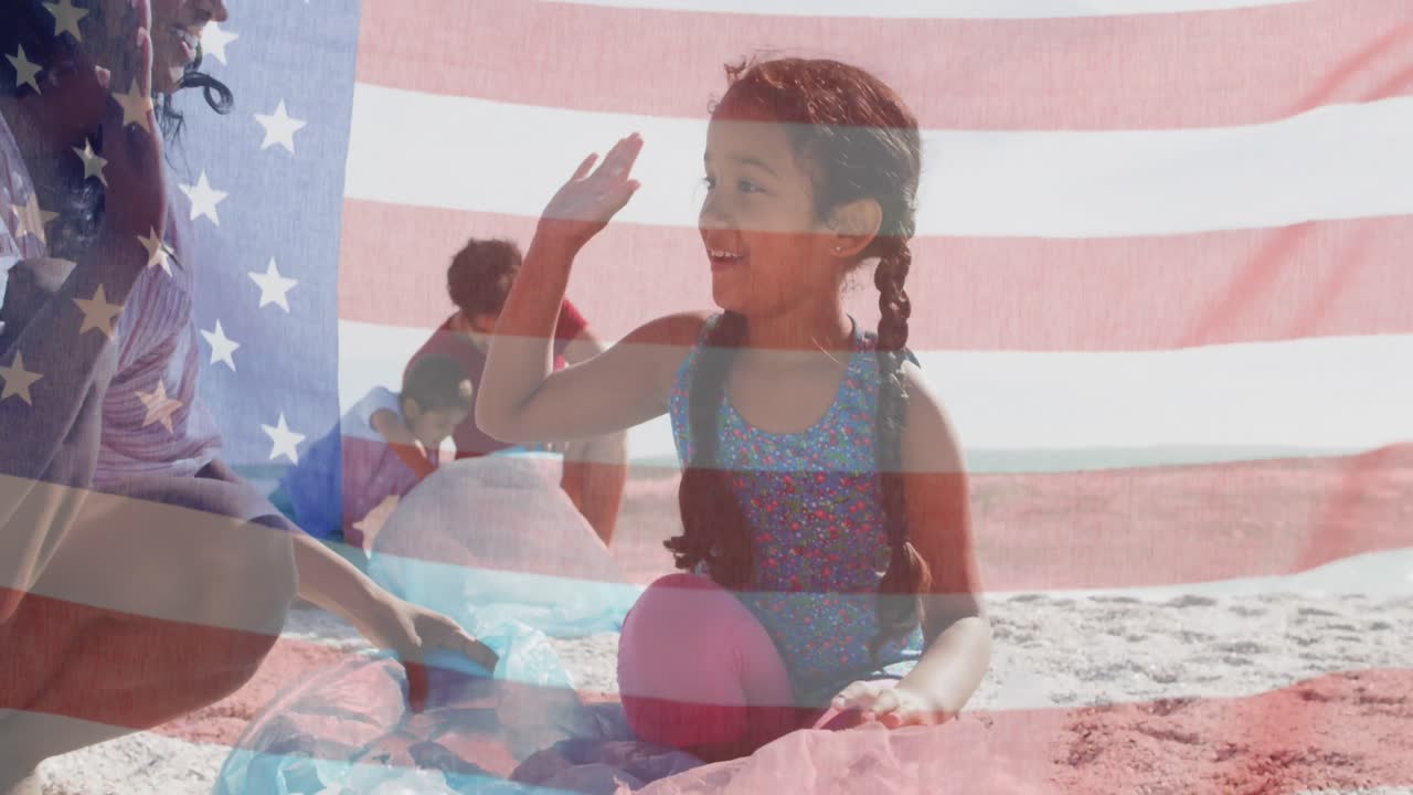 Animation of flag of united states of america over biracial couple with children by seaside