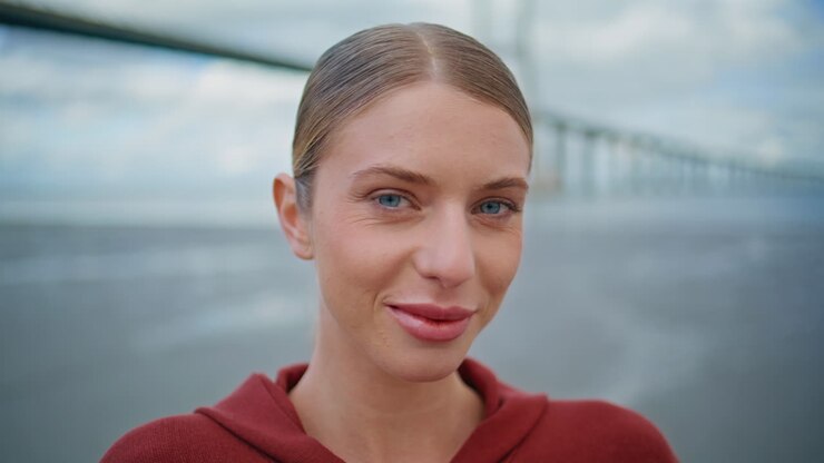 Closeup sporty girl posing city bridge. Smiling urban athlete look away at sea
