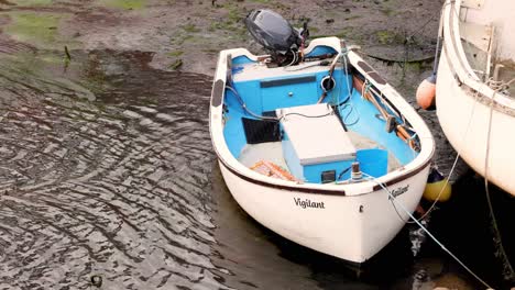 small boat named vigilant docked in harbor