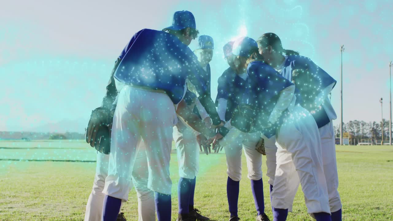 Team members reaching inward initiating pregame baseball huddle extending gloves glowing on field