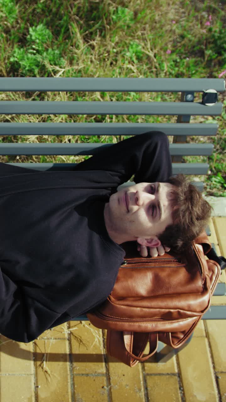 Tired Student Sleeping On The Park Bench After School