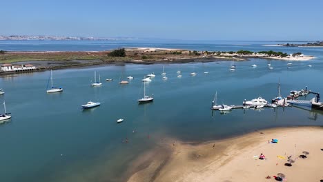 drone shot tilting up and descending by the anchored yachts near seixal in portugal