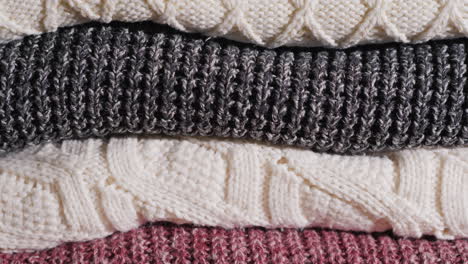 warm knitted clothes lying neatly stacked on the shelf knitted winter clothing