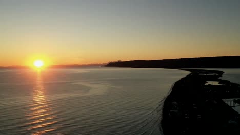 beautiful timelapse of the sunset over the flat rippling ocean and the shores with its beautiful orange glow