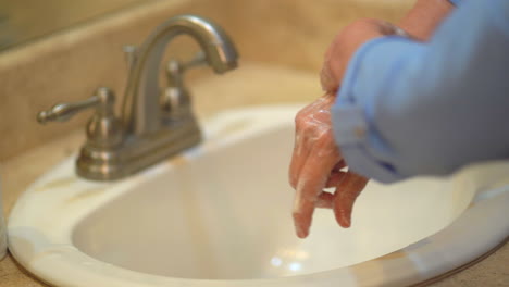 woman properly washing hands in bathroom