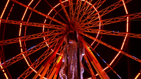 statue of ali and nino on a background ferris wheel at night on the embankment of batumi, georgia