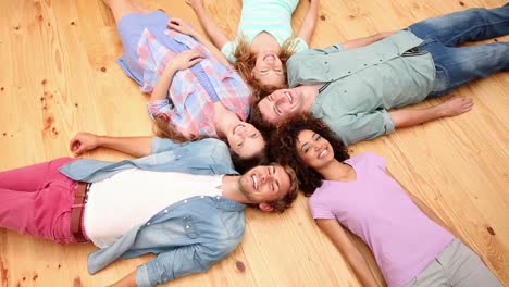 students lying on floor in a circle