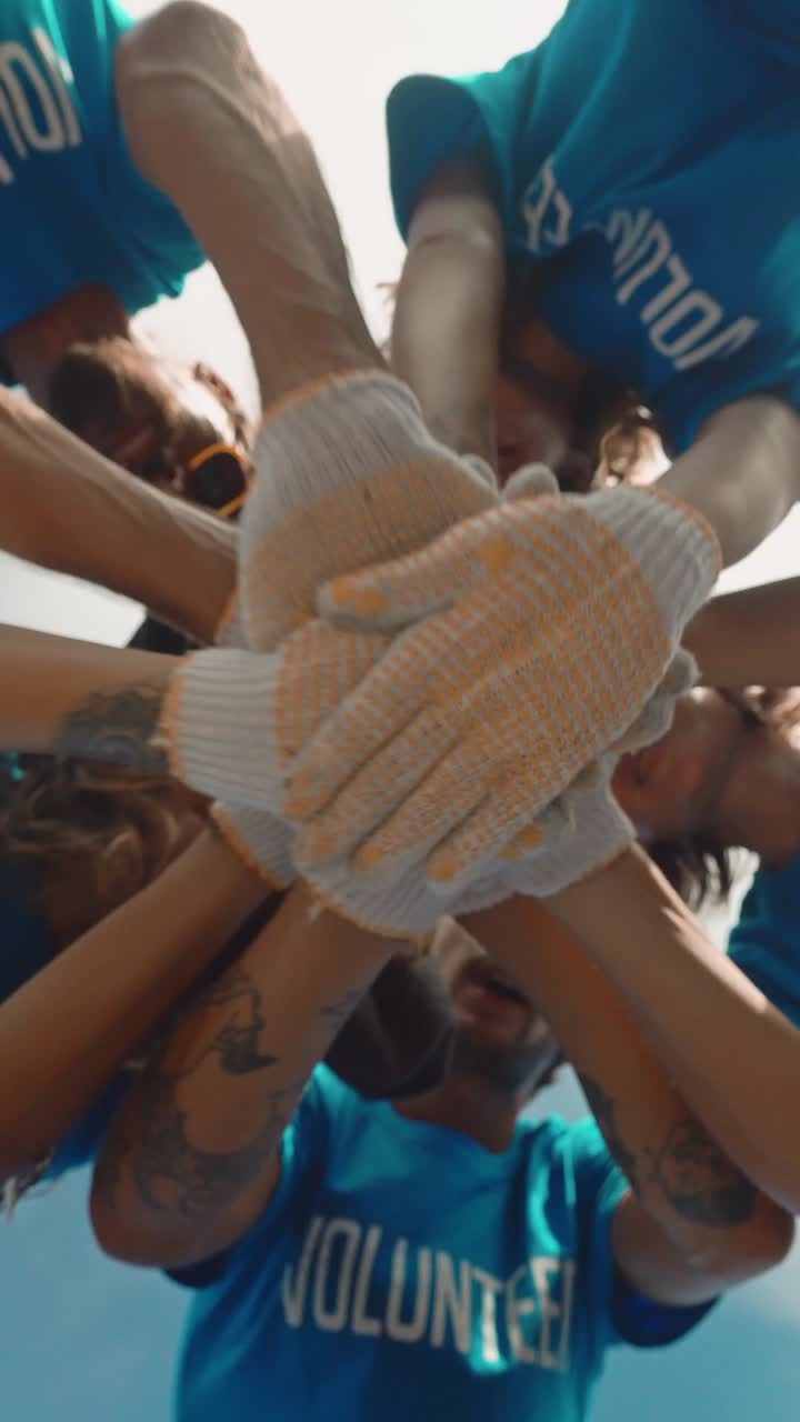 Young joy environmental activists put hands together and say motivational speech