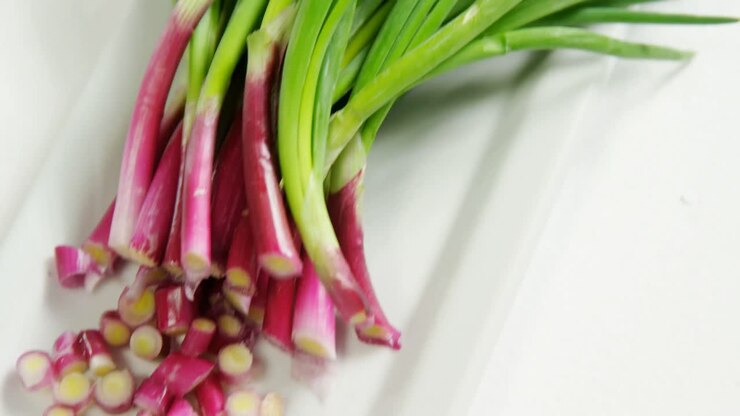 Chopped spring onion placed on white plate 4K 4k