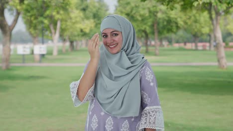 happy muslim woman doing adaab in park