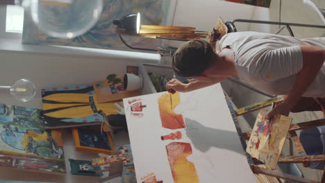 man painting picture in art studio