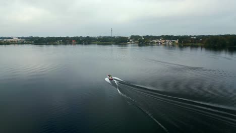 Barco-De-Esquí-Conduciendo-En-Un-Lago-Tranquilo-En-Winter-Haven-Florida-En-Invierno-En-Un-Día-Nublado