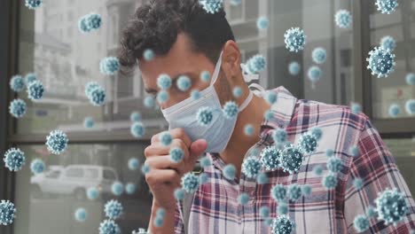 animation of virus cells and biohazard sign over caucasian man wearing face mask and coughing