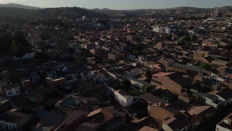 night evening dusk aerial of sucre, bolivia showing bright grid of streetlights and darkened rooftops