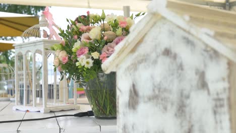 sliding shot behind a wooden craft to a flower at an wedding ceremony