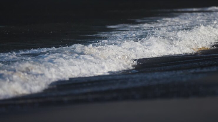 Waves roll on the sandy beach in Ersfjord