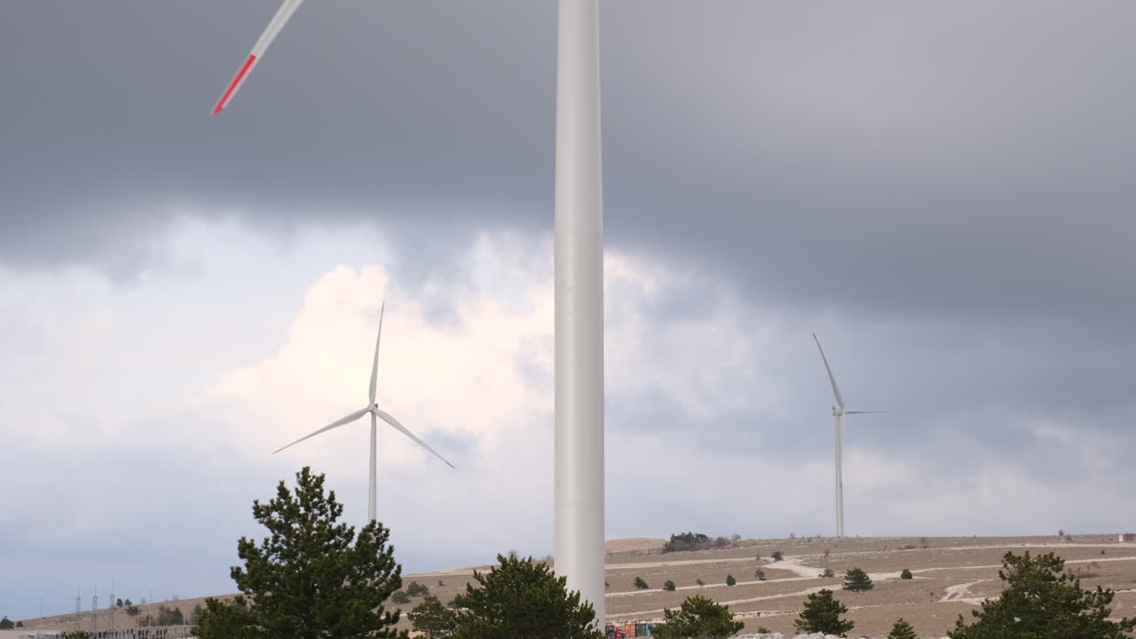 Wind Turbines on a Hilltop under a Cloudy Sky