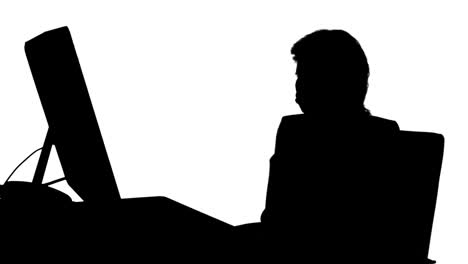 businesswoman filing her nails at her desk silhouette