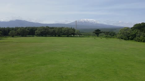 idyllic countryside landscape with mount kilimanjaro in the background - aerial ascend