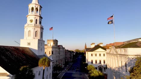 Iglesia-De-St-Michaels-En-Charleston-Sc,-Antena-De-Carolina-Del-Sur-Con-Banderas-Americanas-Ondeando