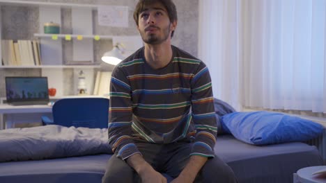 Thoughtful-young-man-feeling-unhappy-in-his-room.