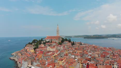 Ascending-aerial-shot-of-a-medieval-town-with-a-tall-church-over-the-houses