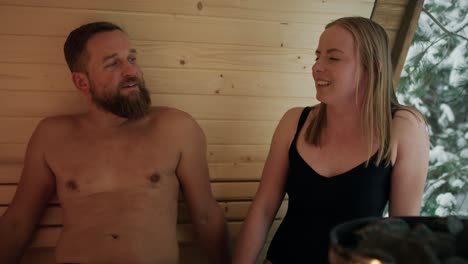 caucasian adult couple enjoying in the sauna in winter.