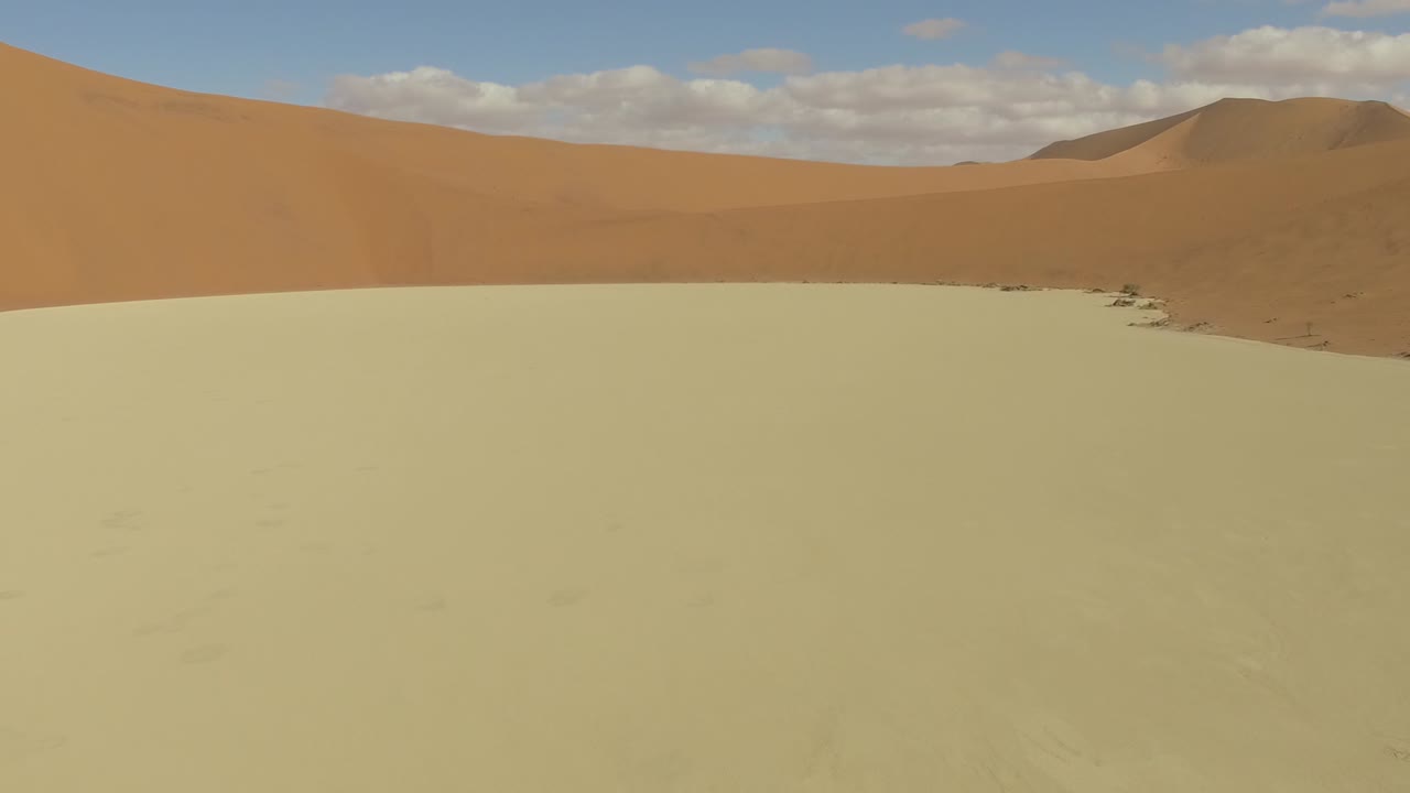 Dried land and red dunes at Deadvlei, drone shot in Namib Desert, Namibia