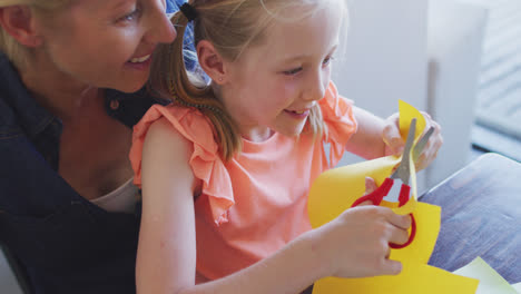 Over-head-view-of-Caucasian-woman-playing-with-her-daughter-at-home