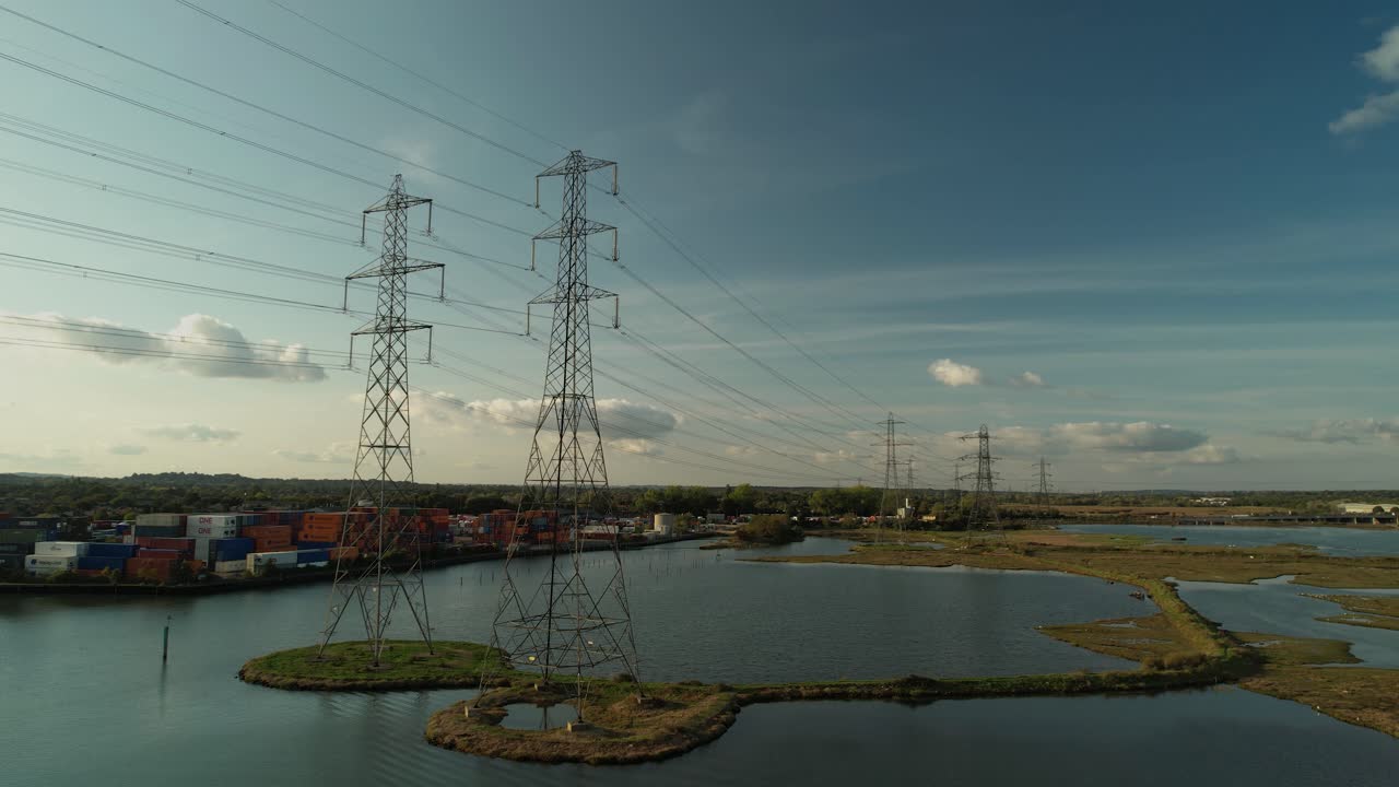 High Voltage Electrical Towers On Water Landscape In Southampton, UK