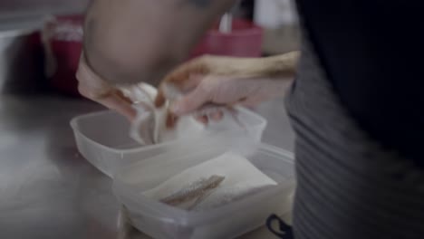 preparing fish in a restaurant kitchen