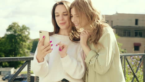 two young women looking at a smartphone