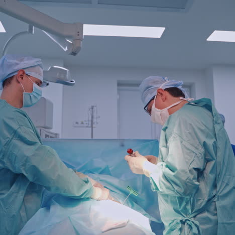 professional doctors in modern clinic. specialists in medical uniform making an operation. health care concept.