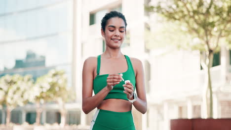 woman running and checking smartwatch in the city