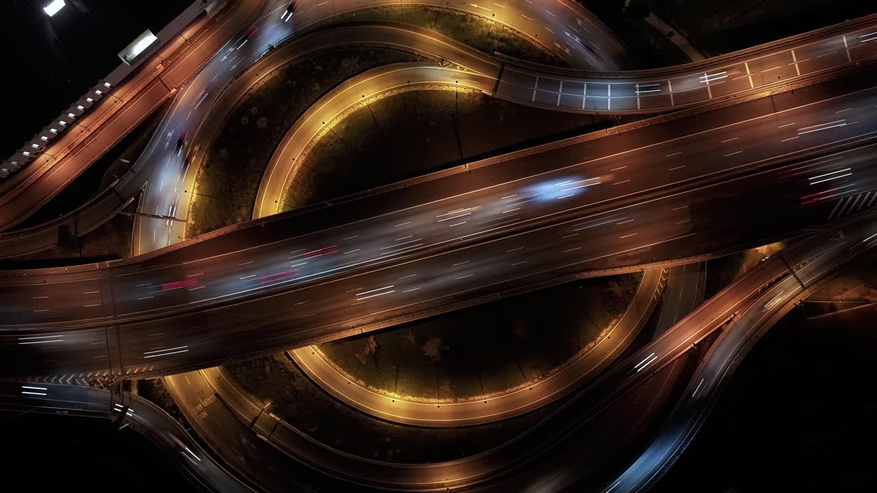 Timelapse of a highway intersection with double roundabouts with a lot of cars