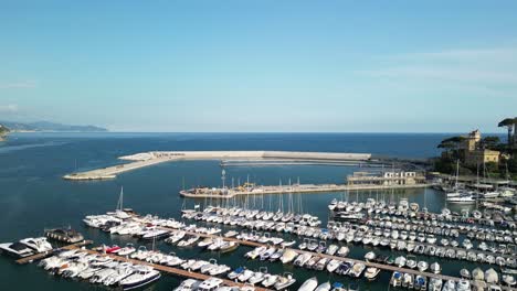 rapallo mediterranean city in ligurian italy, aerial view over blue sea and marina with docked yachts