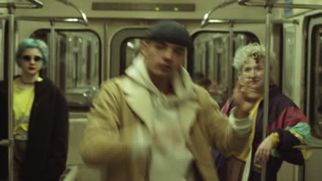 male dancer performing hip hop with girls in subway train