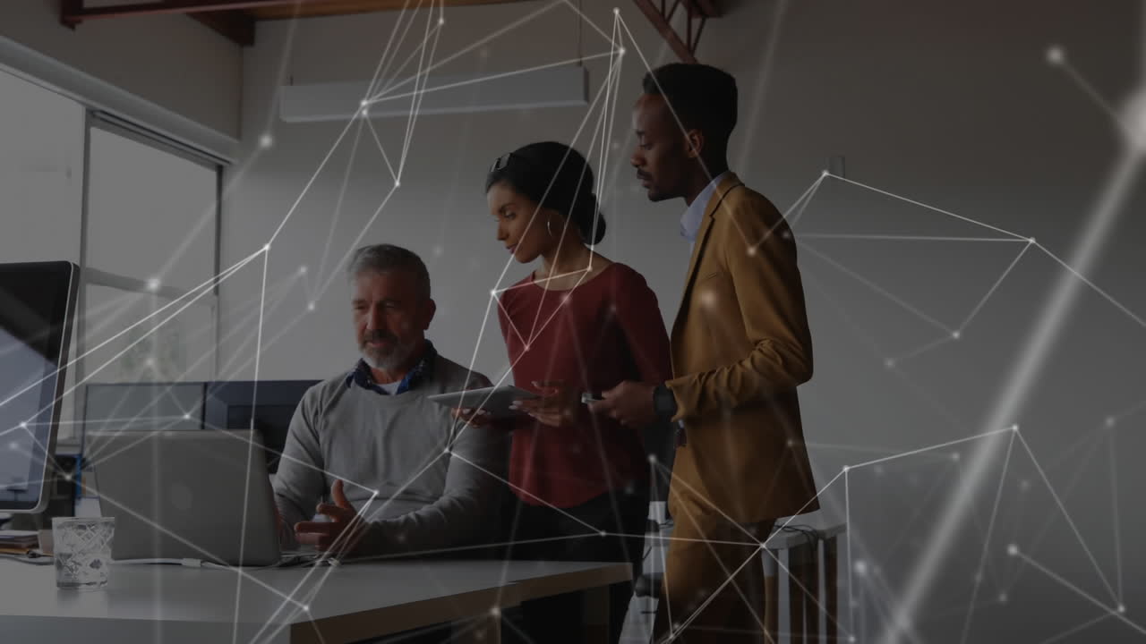 Web of connection icons against people working in office