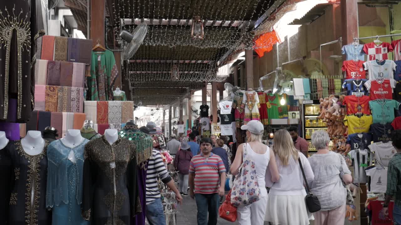 Local Dubai Deira market with persistent sellers wooing tourists