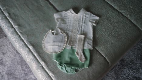 classic baby baptism outfit laid out on soft fabric for ceremony prep