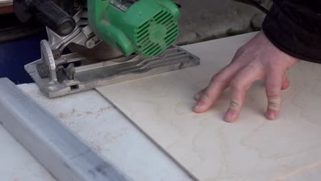 cutting wood with an electric hand saw. woodworking.