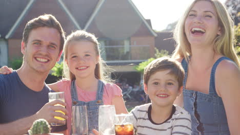 portrait of family enjoying outdoor summer drink at pub