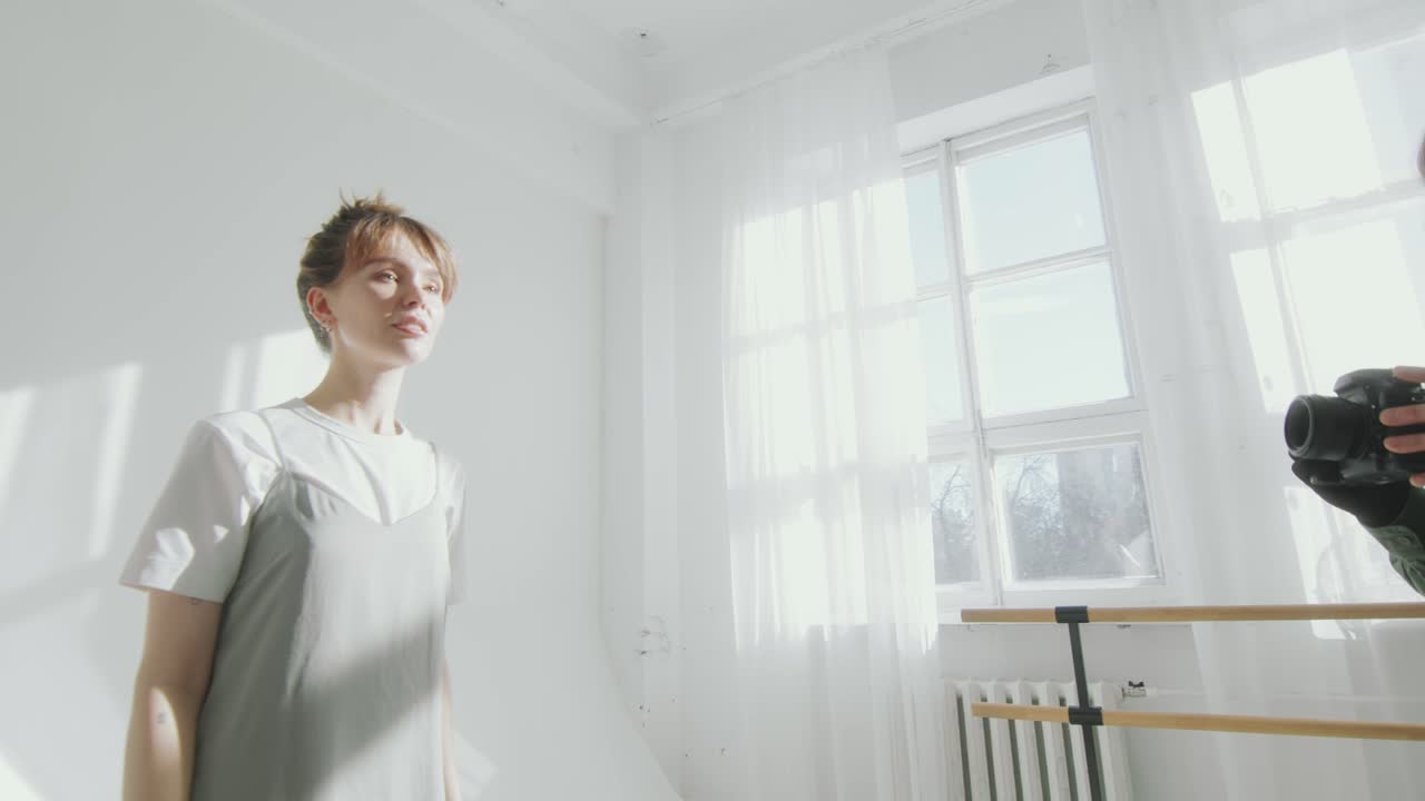Young Attractive Model Posing on White Cyc Wall during Photo Shoot