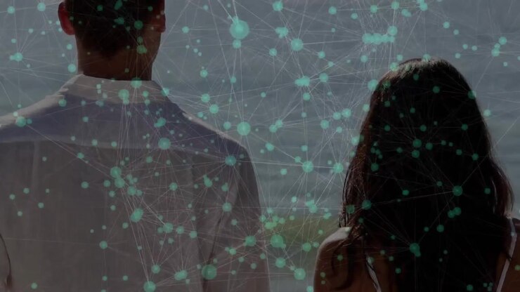 Couple releasing hands and walking to reach shoreline while digital network overlay connecting them
