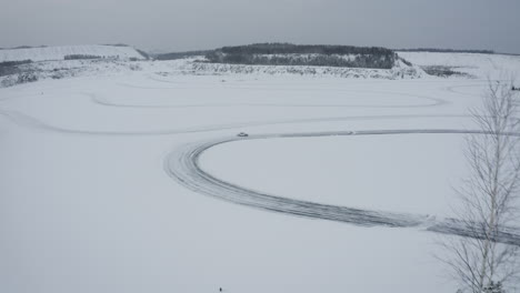 car driving on a frozen lake race track in winter